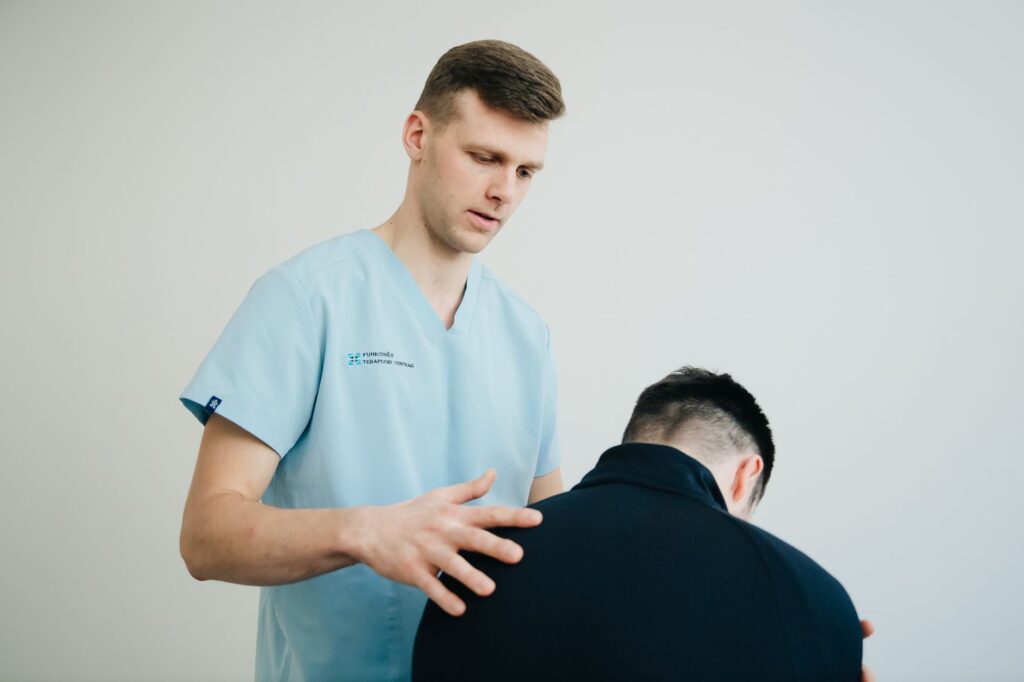 Healthcare professional conducting assessment of patient mobility and strength