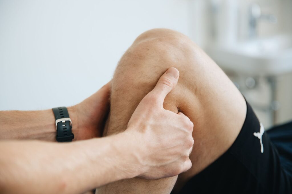 Patient performing knee strength exercises with therapist guidance