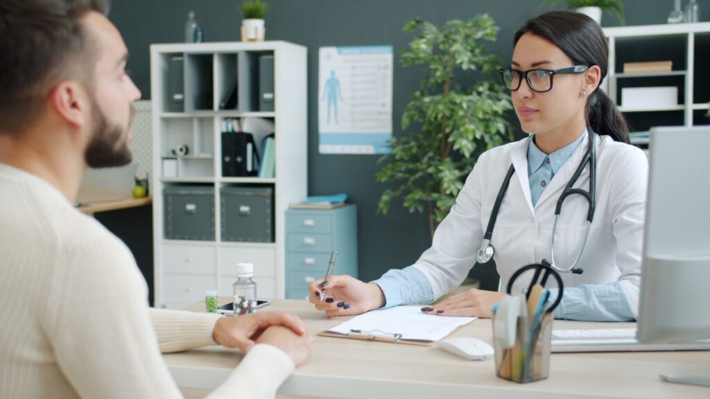Patient receiving consultation and treatment planning at physiotherapy clinic